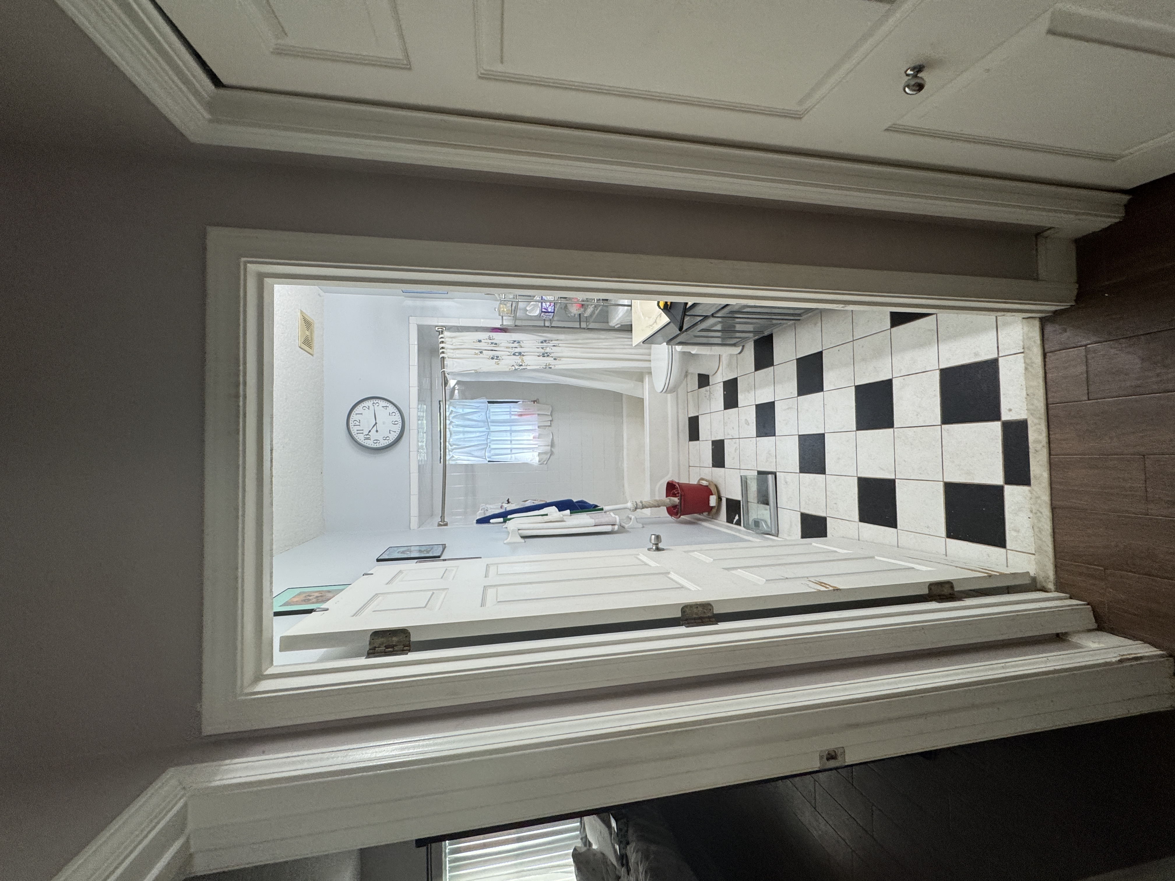 Bathroom with dated tub enclosure before remodel